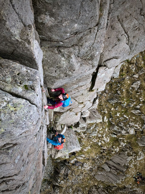 Two climbers ascending the steep corner of the Dolmen Ridge on Glyder Fach