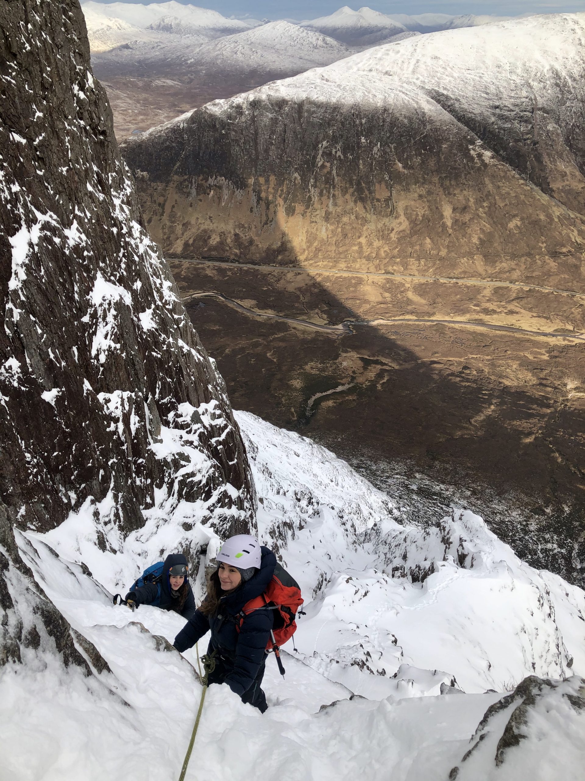 Two climbers making their way up Curved Ridge in Glencoe in full winter conditions
