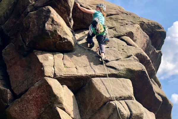The hanging groove of the classic route Flying Buttress at Stanage during a Learn to Lead rock climbing course in the Peak District