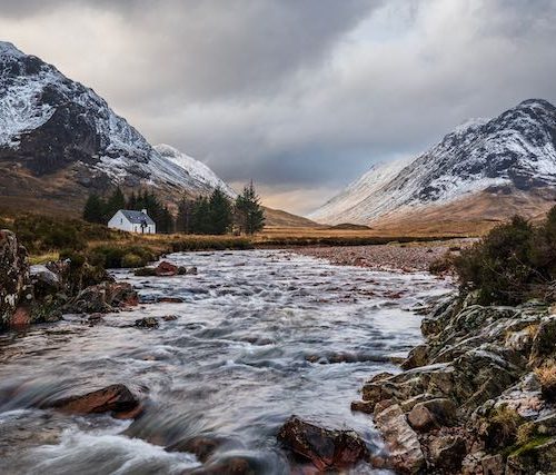 The white cottage of Lagangarbh with Buchaille Etive Mor and Buchaille Etive Beag in the background