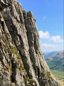 Gimmer Crag, in Great Langdale, with lots of pairs of climbers enjoying a multi-pitch rock climbing course as can be done in the Lake District and Snowdonia
