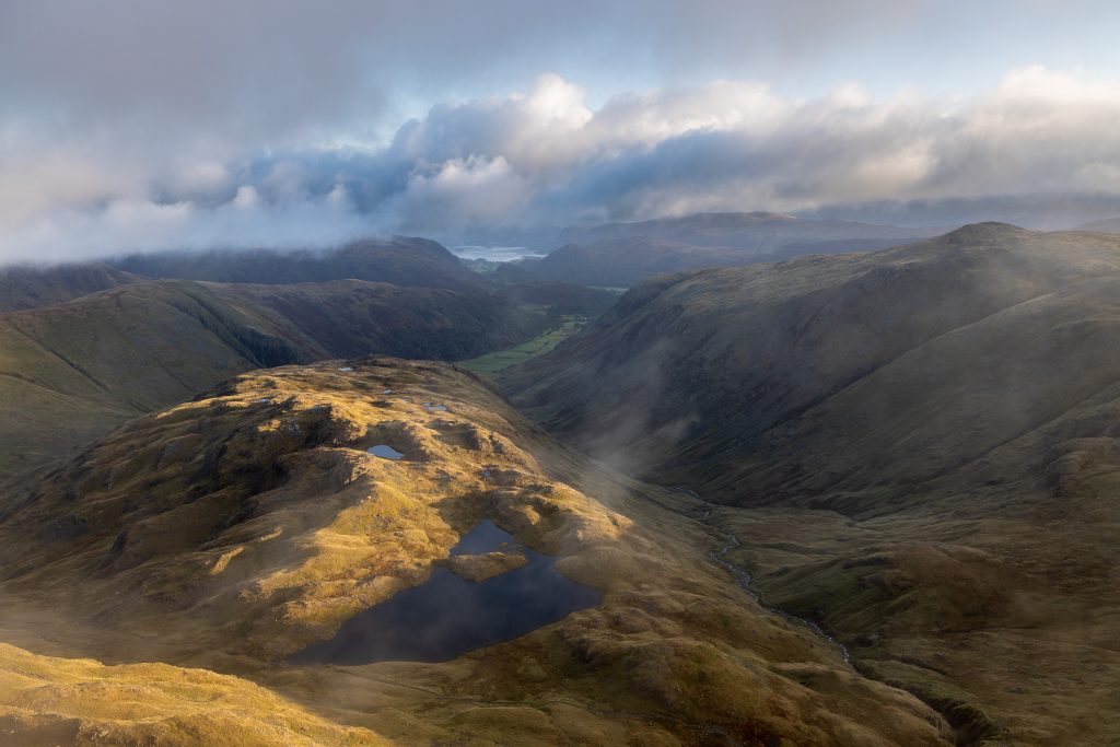 An early morning view from Great End in the Lake District looking down at Sprinkling Tarn and Borrowdale to Derwent Water