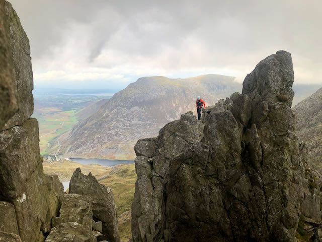 A climber standing on one of the pinnacles on Bristly Ridge on Glyder Fach