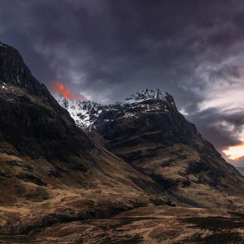 A view of two the Three Sisters Glencoe (Gearr Aonach and Aonach Dubh) with a dramatic sunset in the sky