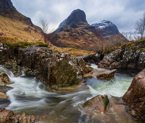 The secret or hidden waterfall below the Three Sisters of Glencoe, with Gearr Aonach towering above