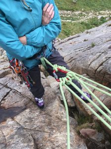 A close up of the rope set up used by someone who is learning about trad climbing belays on a course