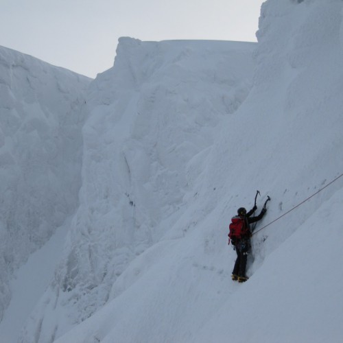Climber on the Eastern Traverse, Tower Ridge, Ben Nevis in deep snow conditions
