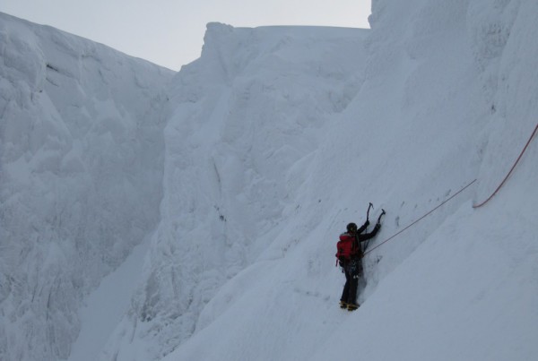 Climber on the Eastern Traverse, Tower Ridge, Ben Nevis in deep snow conditions