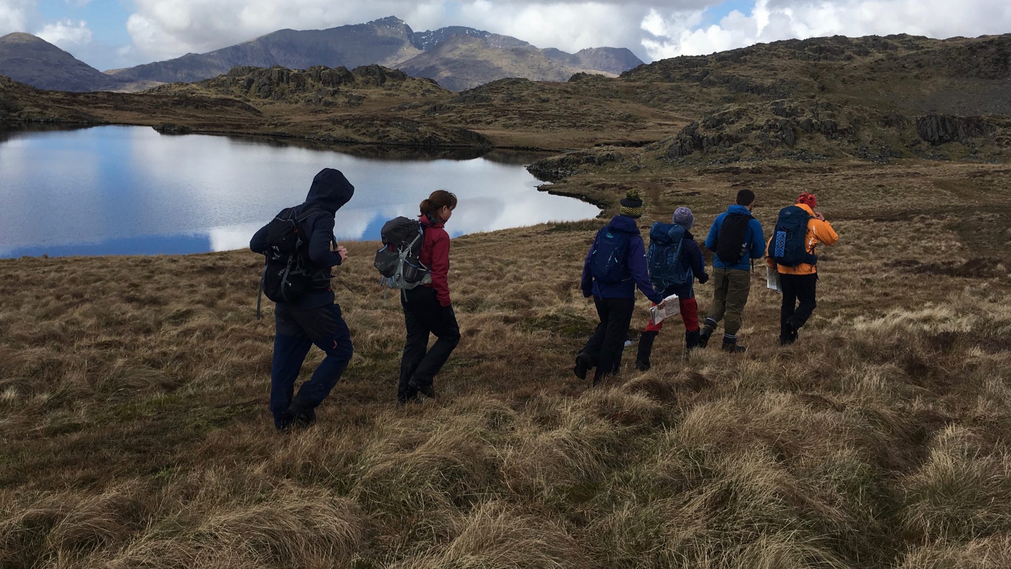 A group on a mountain walk in Snowdonia with a guide